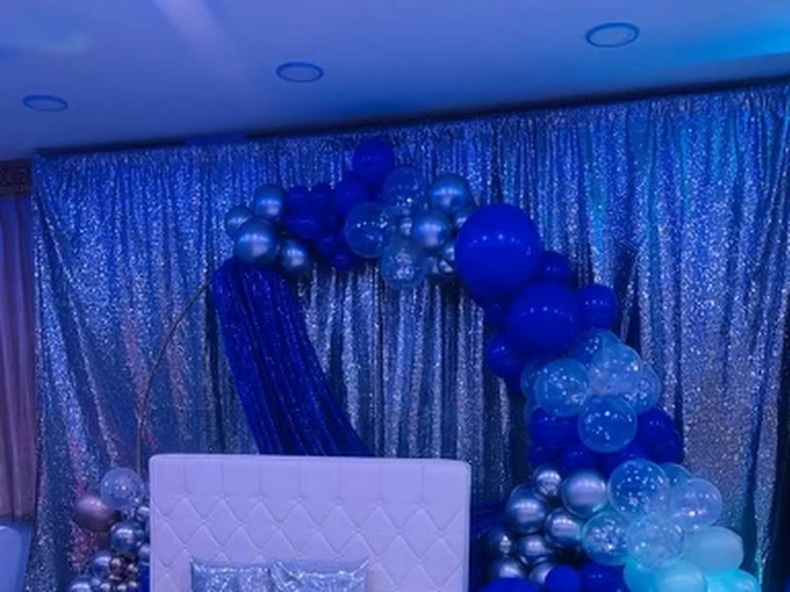 Blue birthday balloon installation and seating