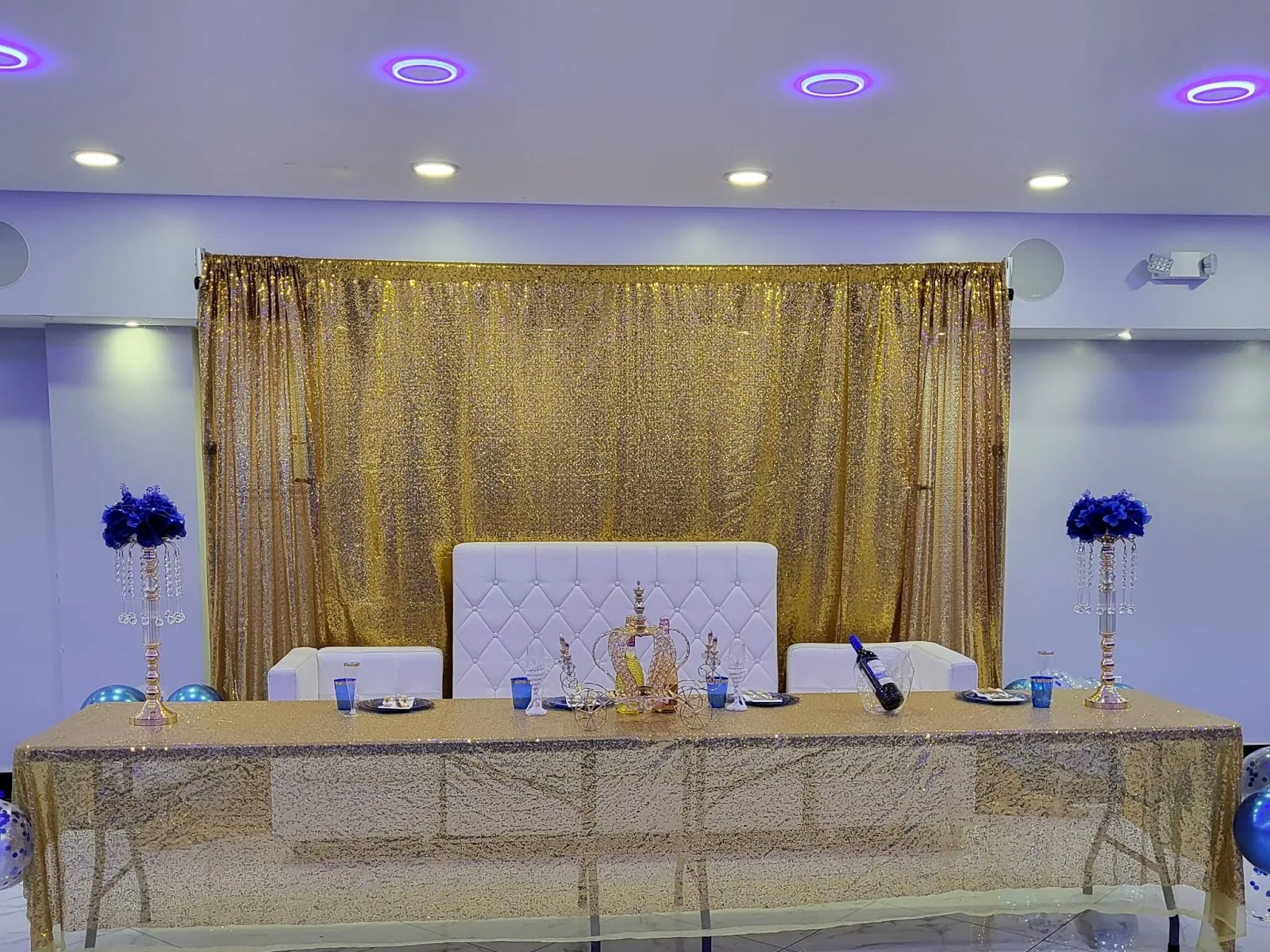 Gold ceremony table and reception backdrop
